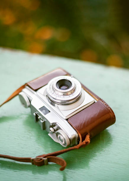 istock Vintage camera on wooden background 1334092051