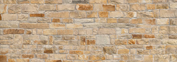 istock Old beige brown panoramic natural stone wall 1334092059