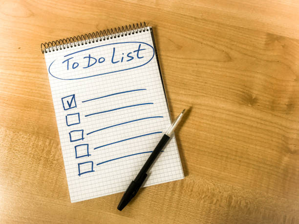 istock to do list checklist hand written on notepad paper lay on wooden table. pen lay on notepad 1334094422