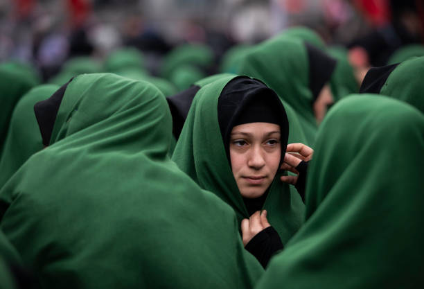 Crowd of young Shiite muslim women take part in a mourn ceremony during the remembrance of Muharram (Called Asura) in Halkali, Istanbul Istanbul, Turkey - November 13, 2013: Crowd of young Shiite muslim women take part in a mourn ceremony during the remembrance of Muharram (Called Asura) in Halkali, Istanbul.  Asura is a religious observance marked every year by Muslims to commemorate the martyrdom of Imam Hussein, a grandson of the Prophet Mohammed, in the Iraqi city of Karbala in the seventh century.  The word 'asura literally means "10th," as it is on the 10th day of Muharram, the first month of the Islamic year day of ashura stock pictures, royalty-free photos & images