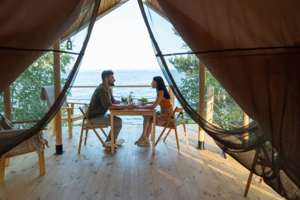 istock Young romantic couple enjoying breakfast on terrace by seaside 1334096737