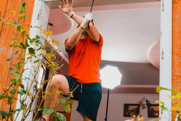 istock A worker dismantles an old window in the house with a crowbar. 1334097781