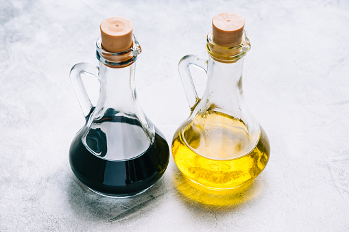Olive oil and balsamic vinegar in bottles on the table. salad sauce