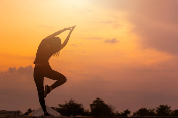 istock Woman doing stretching warm up exercise outdoors against beautiful sunset. 1334098825