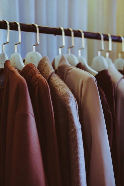 istock Bunch of brown warm cozy clolthes with different material hanging in bunch, clearly visible texture. 1334101760