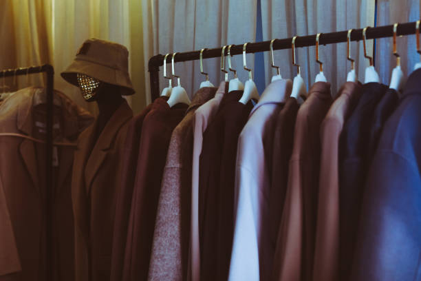 istock Brown beige warm cozy clothes with different material hanging on a clothing rack , clearly visible texture. 1334101772