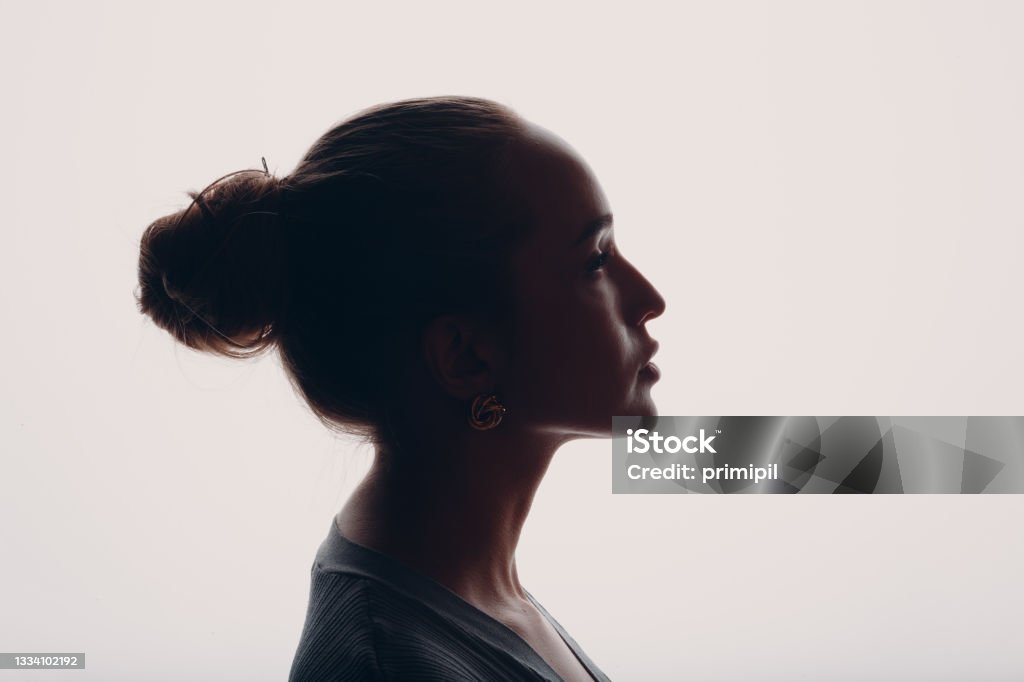 Adult young woman silhouette portrait in studio. Adult young woman silhouette portrait in studio Profile View Stock Photo