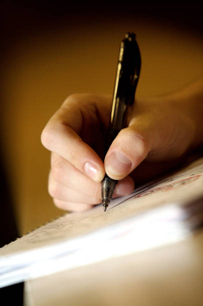 istock White male hand and pen writing on notepad 1334103073