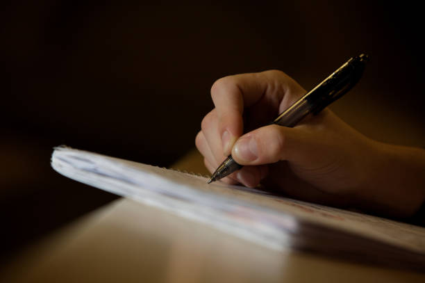 istock close up of hand notepad and pen 1334103074