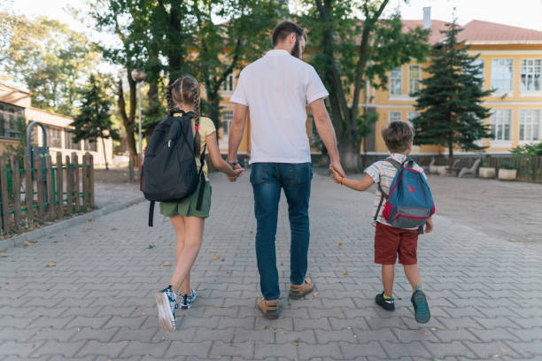 istock Father taking the kids to school 1334103606