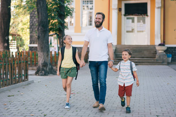 istock Father taking his kids from school 1334103610