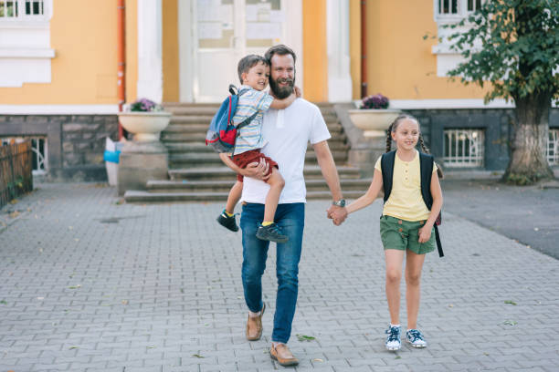 istock Father taking his kids from school 1334103613