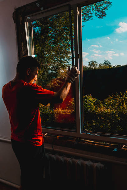 istock The worker inserts glass into the window frame, triple glazing of the plastic window, insulation and insulation. 1334103997