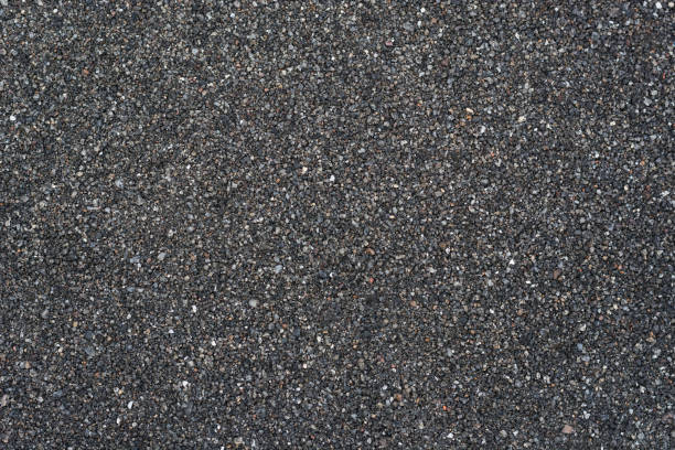 istock small stone pebbles, dark gray and white tone background texture 1334109109