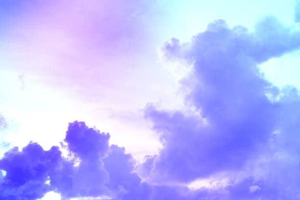 istock beauty abstract sweet pastel soft purple with fluffy clouds on sky. multi color rainbow image. fantasy growing light 1334109740