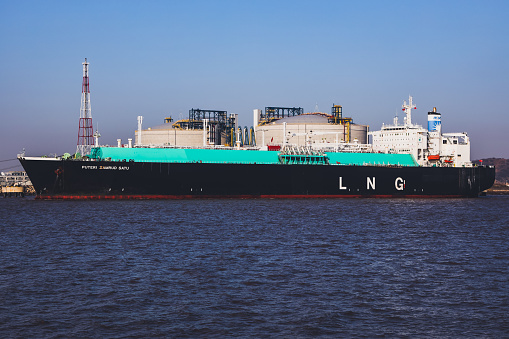 Picture of a large LNG (Liquefied natural gas) tanker ship unloading its cargo at LNG terminal