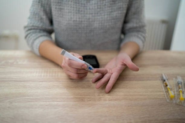 istock Person using diabetes kit on her finger 1334117018