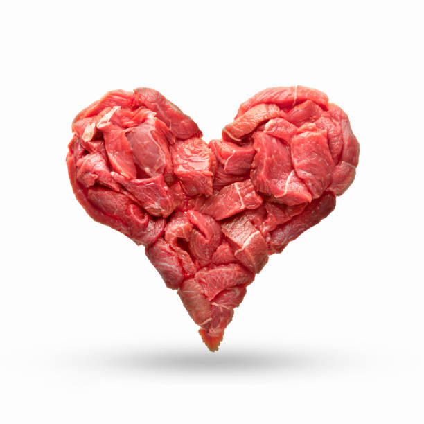 the heart is made from raw meat isolate. beef in the shape of a heart, symbolizes heart disease, overeating, cooking or the meat industry, as well as for Halloween in the composition. the harm of meat for heart diseases or cholesterol, cooking. stock photo