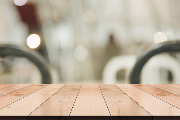 istock Empty wooden table top with lights bokeh on blur restaurant background. 1334118570