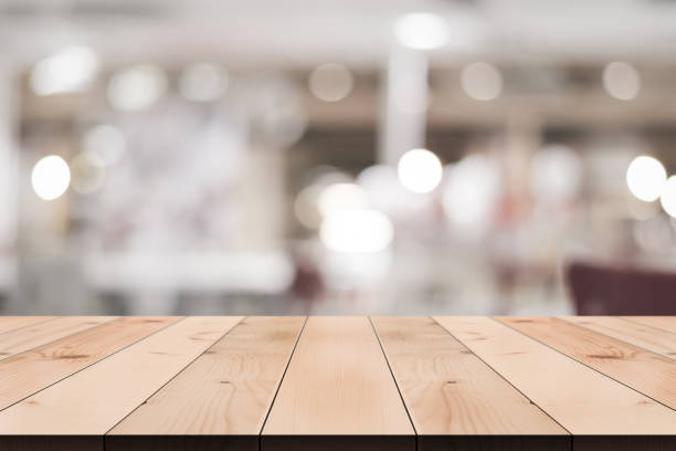 istock Empty wooden table top with lights bokeh on blur restaurant background. 1334118571