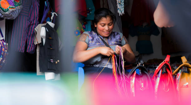 istock woman who uses her hands to make traditional fabrics. 1334119817
