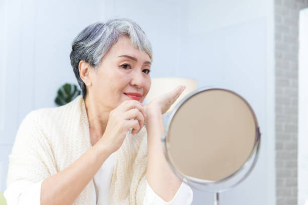 istock Senior Asia woman is spraying perfume. 1334121932