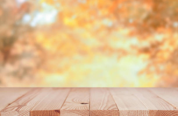 istock Wooden tabletop in the nature blurred background 1334125356
