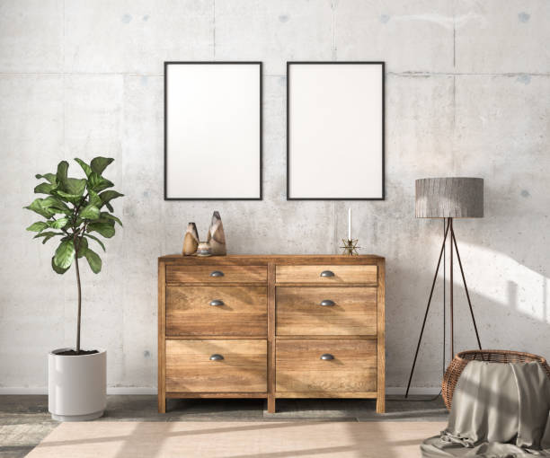 istock Interior scene mockup: wooden sideboard with two empty picture frames, vases and a candle on top. Floor lamp, fig tree and rattan basket with blanket to the sides. Concrete wall. 3d render mockup. 1334125606