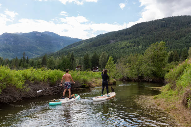 istock Adventurous Hispanic Athletic Man and Caucasian Woman paddle boarding 1334126238
