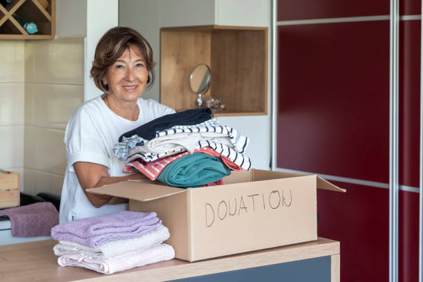 istock Senior woman preparing and packing donations at home 1334126419