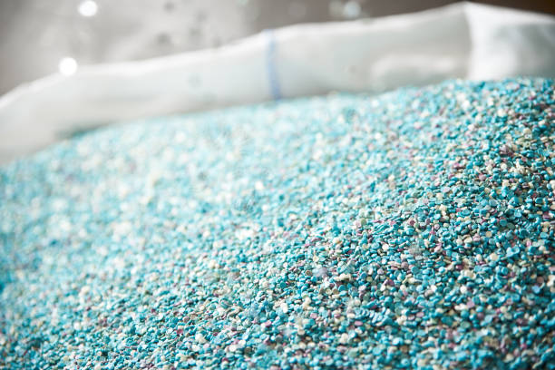 Plastic raw materials - small blue parts for the production of various products Plastic raw materials - small blue parts for the production of various products granule photos stock pictures, royalty-free photos & images