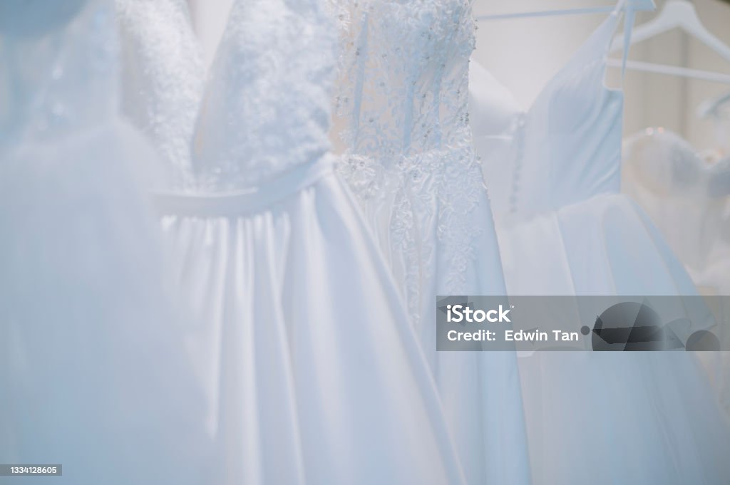 Beautiful wedding dresses on a hanger  in bridal shop Wedding Dress Stock Photo