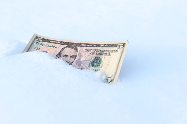 istock a five-dollar bill in the snow, a cold time 1334130921