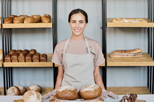 istock Happy young owner of bakery selling fresh bread 1334131827