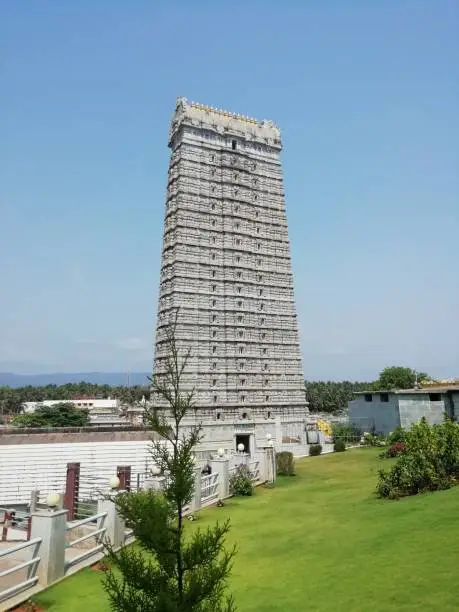 A temple dome ( Murudeshwar Gopuram or Srirangam Temple gopuram) ancient architecture temple carving design surrounded by landscapes. This is the second tallest dome in the world. near to Siva statue