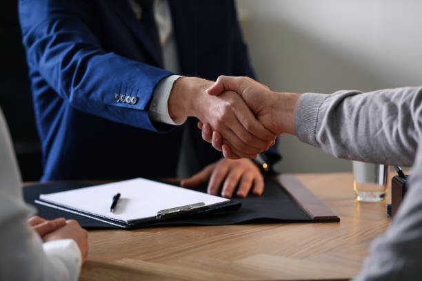 istock Male lawyer working with clients in office, closeup 1334132779