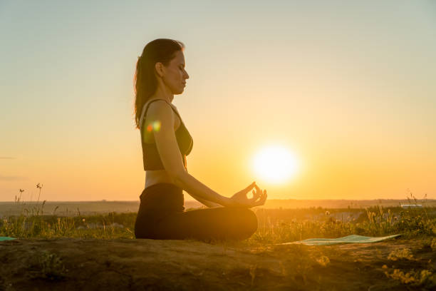istock Yoga woman meditating at sunset 1334134919