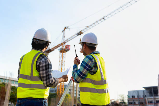 istock Construction engineers discussion with architects at construction site or building site of highrise building with Surveying for making contour plans is a graphical representation of the lay in land. 1334138269