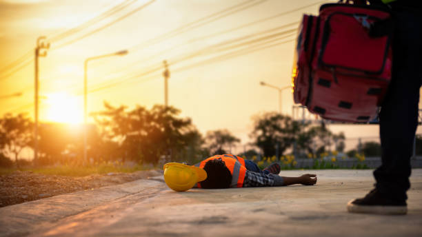 Accident at work of construction labor people, Basic First aid and CPR Training at outdoor. Heat Stroke or Heat exhaustion in body concept. stock photo