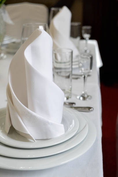 istock Serving table, wine glasses, plates, napkins and cutlery, festive dinner table design, service in restaurant or cafe, selective focus 1334139332