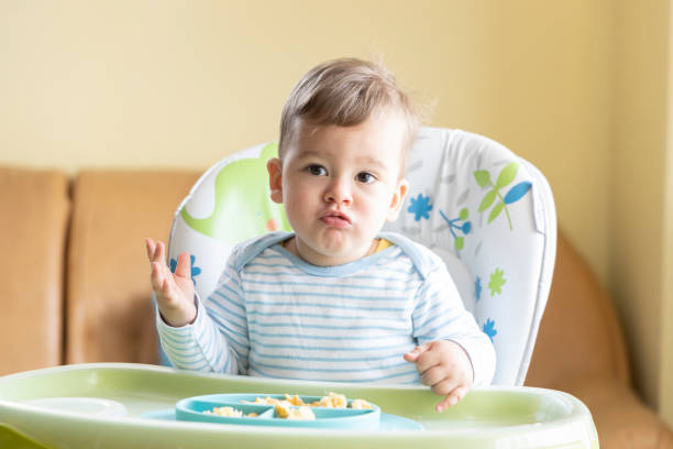 istock little cute baby eating breakfast 1334139952