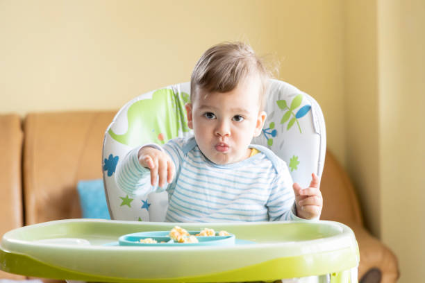 istock little cute baby eating breakfast 1334139955