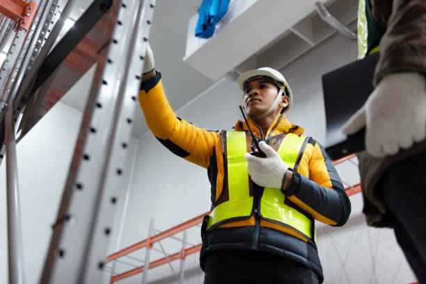 istock Maintenance technician service in cold warehouse storage, Machinery engineering people checking moving rack system and equipment in warehouse. 1334140340