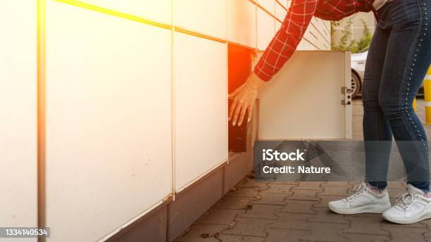 Post Terminal Parcel Courier Box In Woman Hands At Delivery Automat Terminal Online Selling E Commerce Packing Concept Stock Photo - Download Image Now