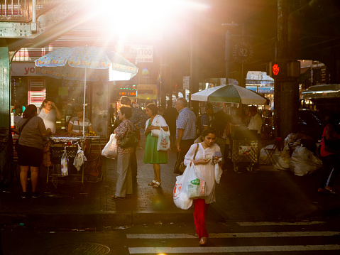 New York City, USA- September 11, 2018:  Busy street life in during sunset in the Jackson Heights neighborhood of Queens.