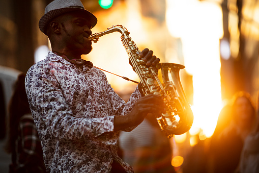 New York City, USA - June 15, 2018:  A street jazz musician performs during sunset in midtown Manhattan.
