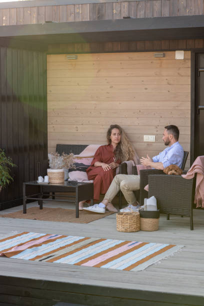 istock Young married couple relaxing on patio in the evening 1334146089