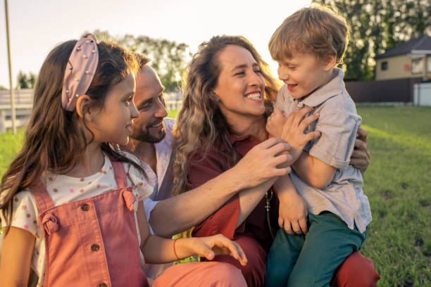 istock Cheerful young parents playing with their two adorable kids 1334146145