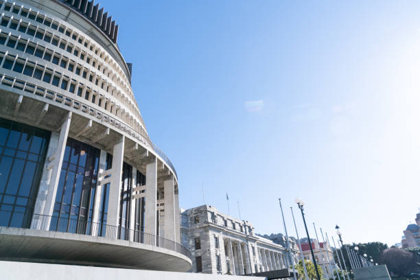 New Zealand government buildings including circular landmark known as Beehive. New Zealand government buildings including circular landmark known as Beehive or executive wing from low point of view under blue sky. beehive new zealand stock pictures, royalty-free photos & images