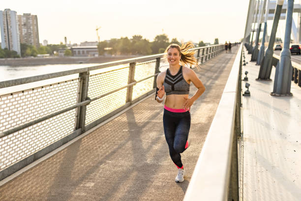 istock Athletic woman jogging at the bridge 1334149331
